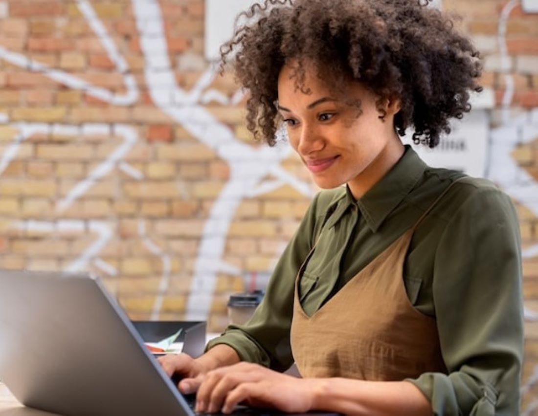 Young woman looking at her laptop